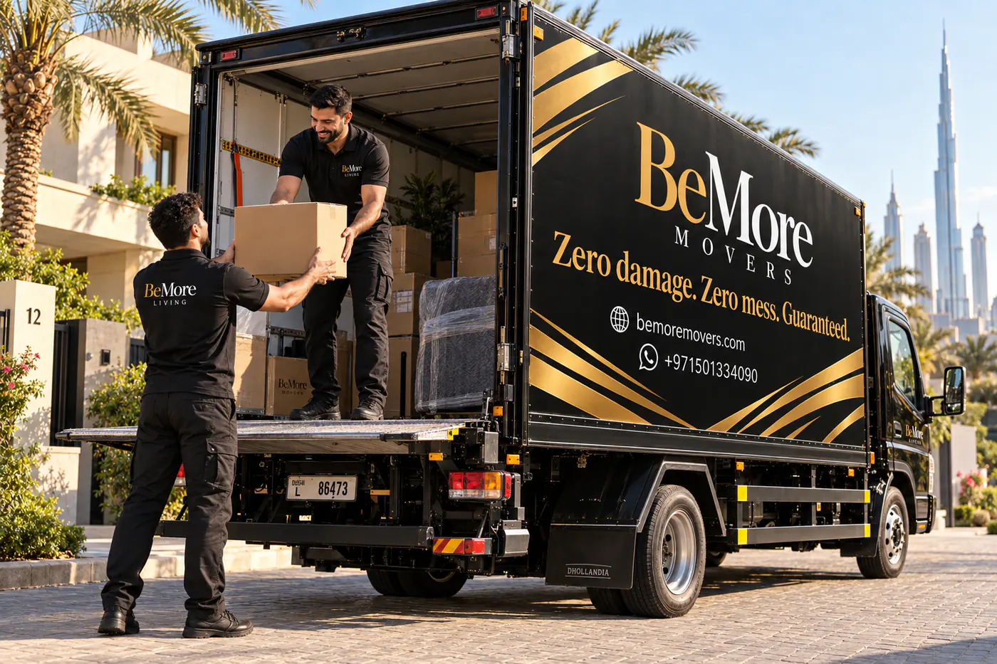 BeMore Movers crew passing cartons up to the tail lift of the moving truck